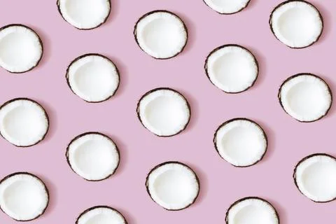 Coconut pattern on the pink background. Set of coconut halves. Stock Photos