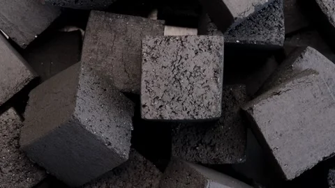 Coconut pressed coal cube rotating smoothly in circle highlighting porous Stock Footage 311326091