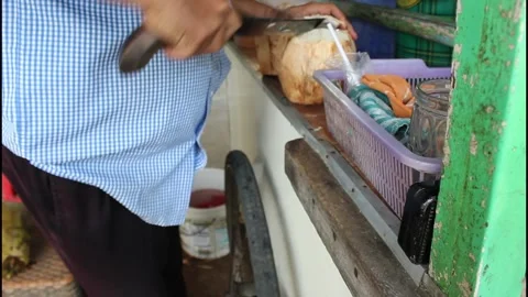 Coconut seller is peeling coconut Stock Footage 340993375
