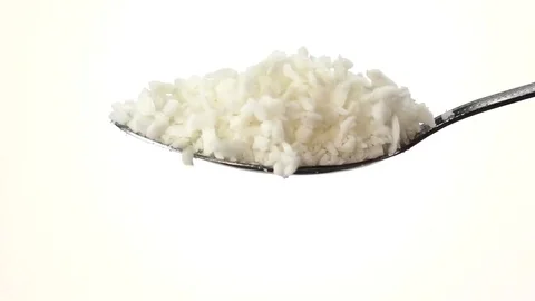 Coconut shaving falling from the iron spoon. White background. Slow motion Stock Footage 75524779