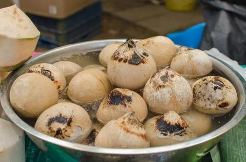 Coconut shell was burn by fire for beverage at the market Stock Photos