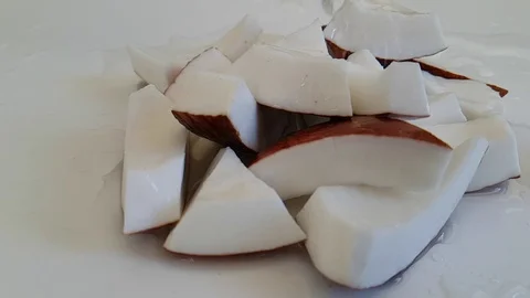 Coconut slices, slow-motion shooting, pouring water drops Video stock 89711743
