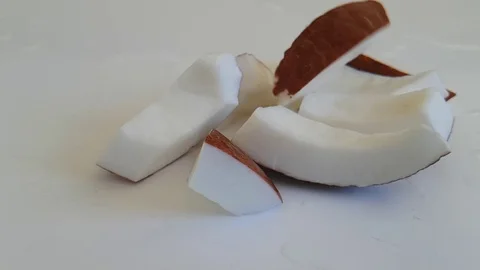 Coconut slices on white Stock Footage 87655698