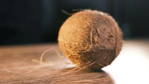Coconut is spinning on the table Stock Footage 194735679