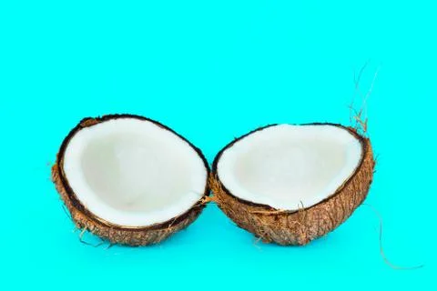 Coconut is split into two parts. Stock Photos