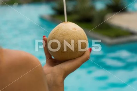 Coconut with straw with 2020 drawing on the beach near the sea Stock Photos