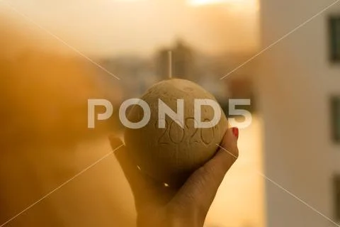 Coconut with straw with 2020 drawing on the beach near the sea Stock Photos
