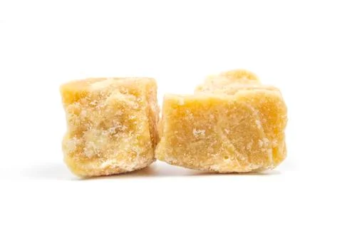 Coconut sugar cubes on white background. Stock Photos