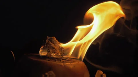 Coconut torch against a dark background. A beautiful flame of yellow-white-red Stock Footage 222452932