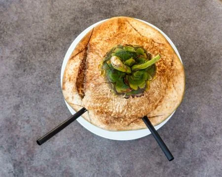 Coconut with two straws Photos