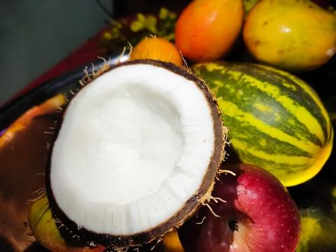 Coconuts and fruit with blurred background. Stock Photos