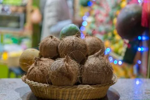 Coconuts in a basket in a bazaar. Pile of coconuts in the basket at the marke Stock Photos