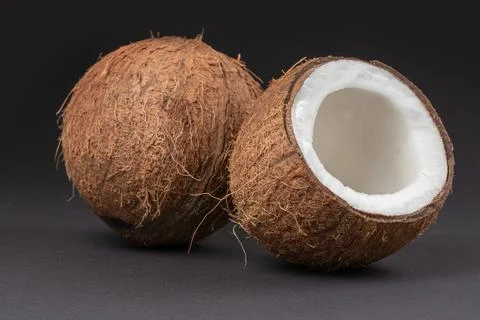 Coconuts on a dark background. half coconut. Stock-Fotos