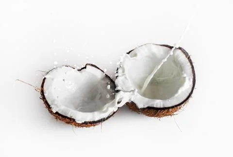 Coconuts with milk splash Stock Photos