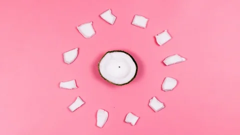 Coconuts on a pink background are moving. Stop the motion. 4k. 動画素材 88398773