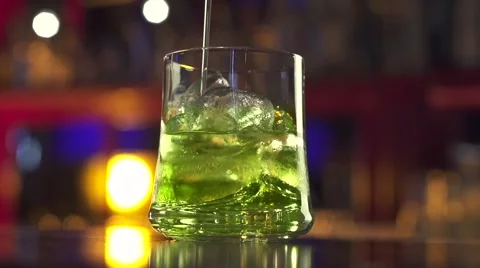 Coctail poured into glass on bar table Stock Footage 55404843