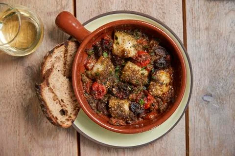 Cod and chorizo bake with grilled sourdough, overhead view Stock Photos
