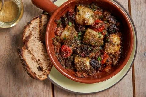 Cod and chorizo bake, grilled sourdough, overhead close up Stock Photos