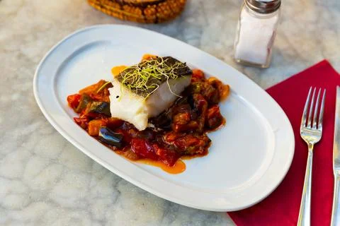 Cod confit with vegetable ratatouille on plate Stock Photos