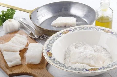 Cod filet in flour placed Stock Photos