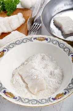 Cod filet in flour placed Stock Photos