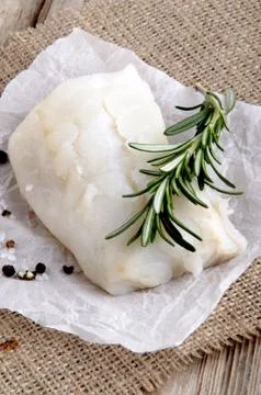 Cod filled with rosemary on kitchen paper Stock Photos