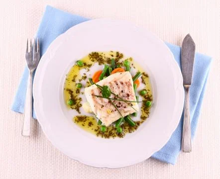 Cod fillet with green beans, peas, parsley, olive oil Stock Photos