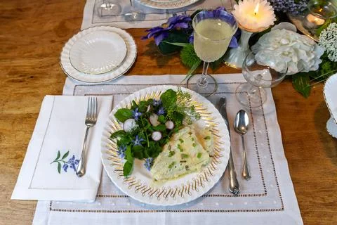Cod fish and spring green salad on fine China Stock Photos
