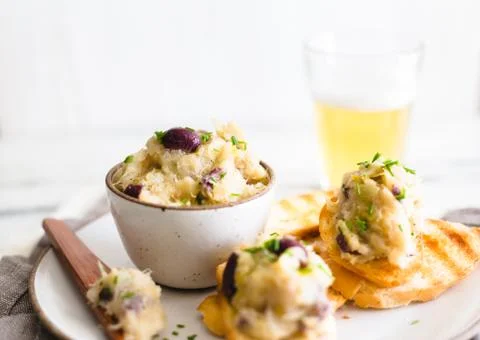 Cod fish brandade on a white ceramic and rustic napkin Stock Photos