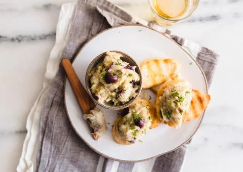 Cod fish brandade on a white ceramic and rustic napkin Stock Photos