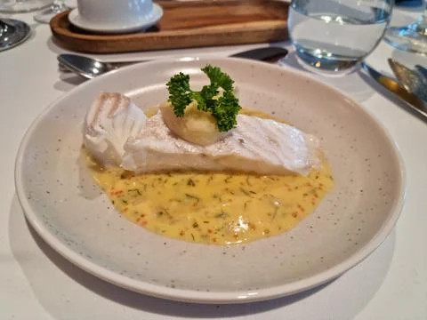 Cod with garnish and sauce at fine resturant setting Stock Photos