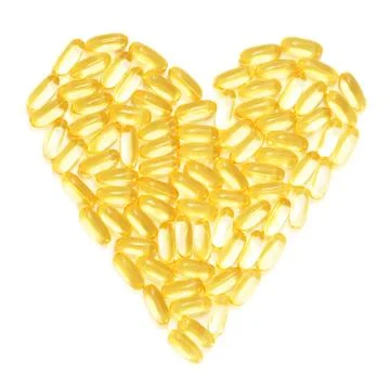 Cod liver fish oil supplements in a healthy heart shape Stock Photos