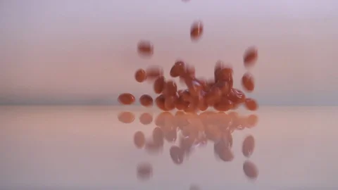 Cod liver oil omega 3 gel capsules falling on white background in slow motion Stockbeeldmateriaal 88742585