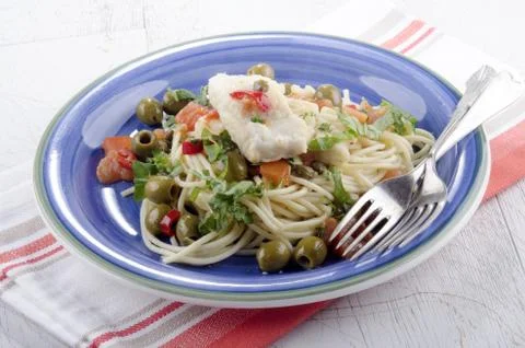 Cod with olive, caper, tomato and parsley Foto stock