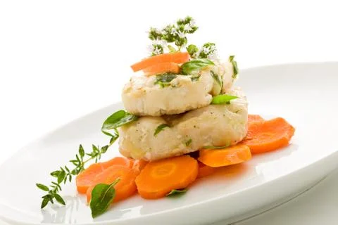 Cod over carrots isolated Stock Photos
