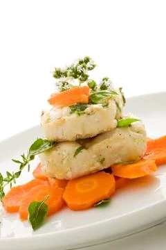 Cod over carrots isolated Stock Photos