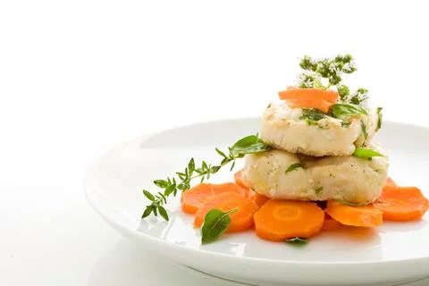 Cod over carrots isolated Stock Photos
