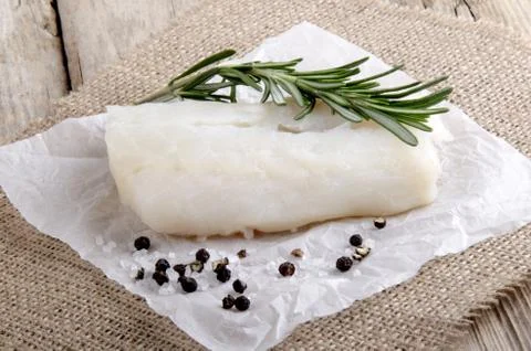 Cod with rosemary on kitchen paper Stock Photos