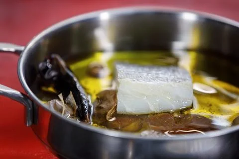 Cod soaking in olive oil Stock Photos