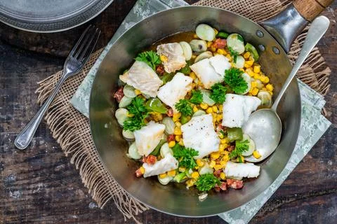 Cod, sweetcorn and broad beans succotash Stock Photos