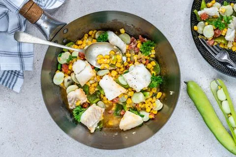 Cod, sweetcorn and broad beans succotash Stock Photos