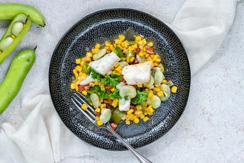 Cod, sweetcorn and broad beans succotash Stock Photos
