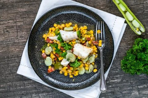 Cod, sweetcorn and broad beans succotash Stock Photos