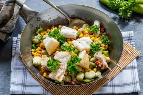 Cod, sweetcorn and broad beans succotash Stock Photos