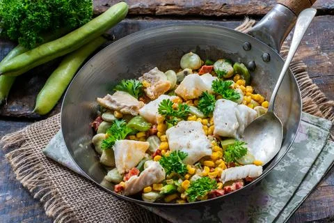 Cod, sweetcorn and broad beans succotash Stock Photos