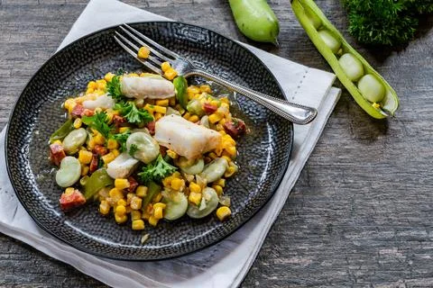 Cod, sweetcorn and broad beans succotash Stock Photos