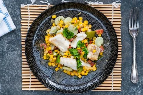 Cod, sweetcorn and broad beans succotash Stock Photos