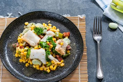 Cod, sweetcorn and broad beans succotash Stock Photos