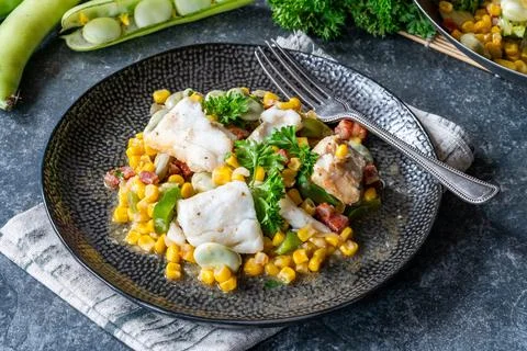 Cod, sweetcorn and broad beans succotash Stock Photos