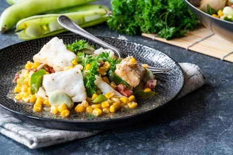 Cod, sweetcorn and broad beans succotash Stock Photos